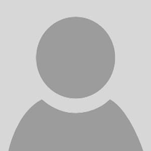 A gray, generic user profile icon with a circular head and shoulders on a light gray background, often used as a placeholder for a profile picture.